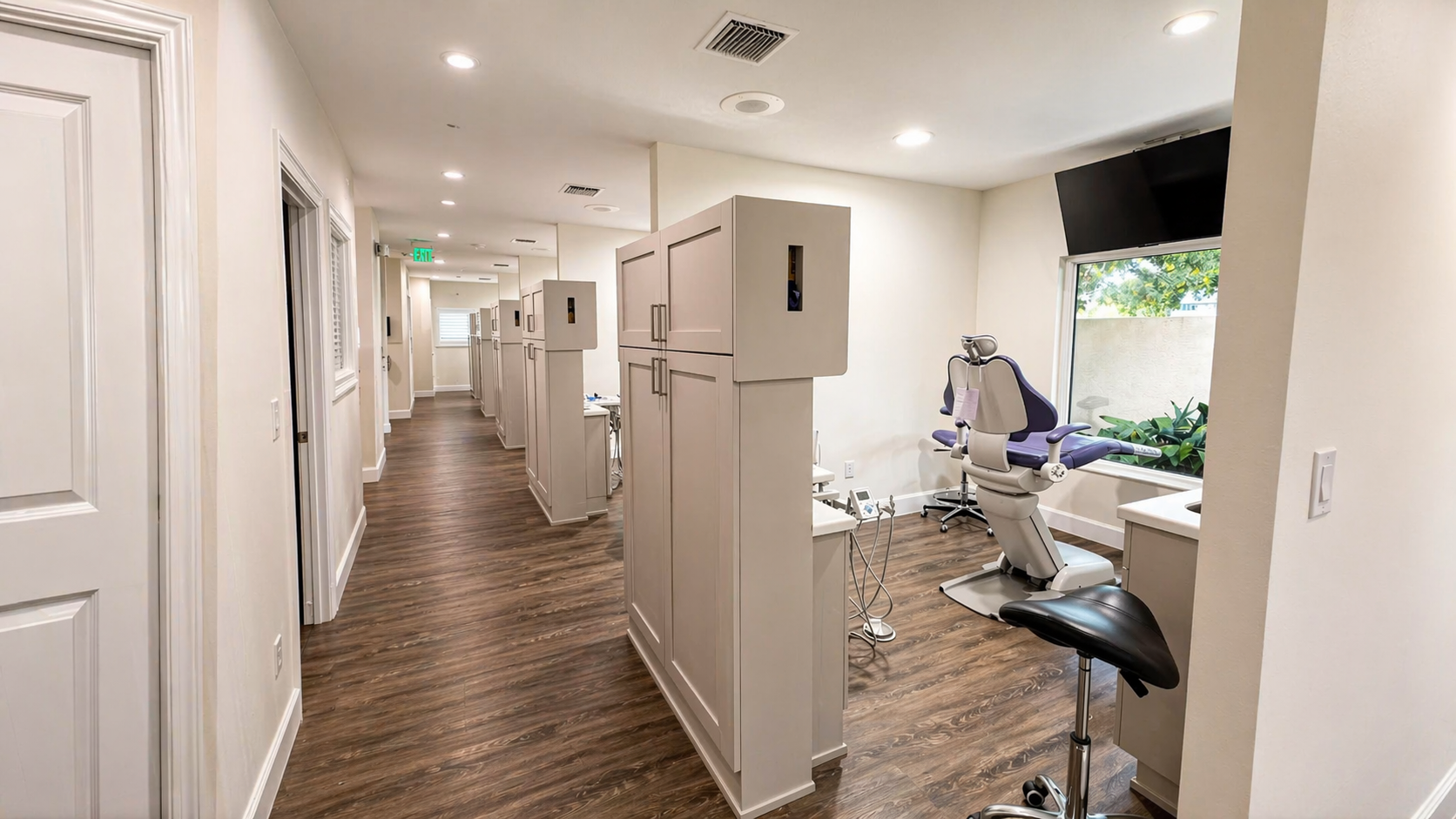 Bright open hallway leading to private treatment rooms with natural light