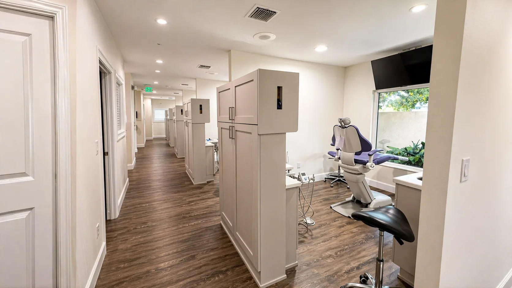 Bright open hallway leading to private treatment rooms with natural light